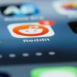 Detailed close-up of a smartphone screen showing the Reddit app with a notification badge.