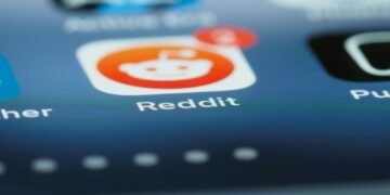Detailed close-up of a smartphone screen showing the Reddit app with a notification badge.