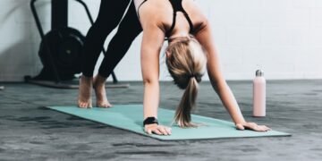 woman in black sports bra and blue denim jeans doing yoga